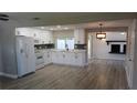 Bright, open kitchen with white cabinets, modern appliances, and stylish backsplash at 3150 Beacon Square Dr, Holiday, FL 34691