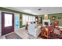 Cozy living room with fireplace, large windows with shutters, and elegant decor at 3898 49Th S Ave, St Petersburg, FL 33711