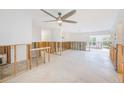 Open-concept living room with ceiling fan, lots of light and easy access to other parts of the home at 3928 E Eden Roc Cir, Tampa, FL 33634