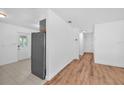 Open concept living space with hardwood floors, white walls, and modern lighting fixtures at 4731 W Leila Ave, Tampa, FL 33616