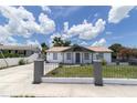 Well-maintained single-story home with fresh exterior paint and landscaping on a sunny day at 4823 Ashland Dr, Tampa, FL 33610