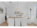 Bright dining room features a modern chandelier, stylish decor, and ample seating for gatherings at 503 W Davis Blvd, Tampa, FL 33606
