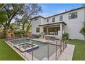 Backyard pool area with a safety fence and a comfortable seating area at 503 W Davis Blvd, Tampa, FL 33606