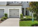 Landscaped exterior with well-manicured bushes and a driveway leading to a single-car garage at 5110 Sylvester Loop, Tampa, FL 33610