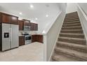 Features an open-concept layout, stainless steel appliances, and dark wood cabinets at 5110 Sylvester Loop, Tampa, FL 33610