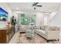 Bright living room featuring modern furniture, neutral color palette, and a view of the outdoors at 5808 Grand Sonata Ave, Lutz, FL 33558