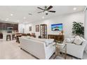 Open-concept living area connecting to the kitchen, featuring modern furnishings and plenty of natural light at 5808 Grand Sonata Ave, Lutz, FL 33558