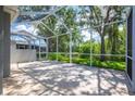 Spacious screened-in lanai offering serene views of the lush backyard and greenery at 6044 Sandhill Ridge Dr, Lithia, FL 33547