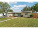 Well-maintained home with a lush lawn, colorful landscaping, and a welcoming entrance at 6167 31St Ave, St Petersburg, FL 33710