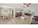 Expansive living room with wood floors, a television, and seamless transition into other living spaces at 6167 31St Ave, St Petersburg, FL 33710