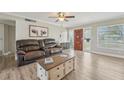 Inviting living room boasting wood floors, a ceiling fan, and an abundance of natural light at 6167 31St Ave, St Petersburg, FL 33710