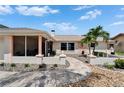 Charming single-story home with a well-maintained walkway leading to the front door and screened porch at 6334 Cocoa Ln, Apollo Beach, FL 33572