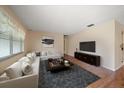 Bright living room with neutral walls, modern furniture arrangement, and sleek hardwood flooring, creating a cozy space at 6530 68Th N St, Pinellas Park, FL 33781