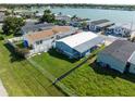 Aerial view featuring a well maintained backyard, complete with a chain-link fence, and lush green grass at 8443 Fantasia Park Way, Riverview, FL 33578