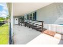 Exterior porch view with wooden stairs, handrails, and accessibility ramp leading to the entrance at 8443 Fantasia Park Way, Riverview, FL 33578