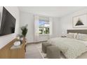 Inviting bedroom with neutral decor, a large window, and comfortable furnishings at 10426 Cross River Trl, Parrish, FL 34219