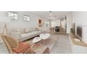 Bright, airy living room with tile flooring, modern furnishings, and access to the dining area at 10426 Cross River Trl, Parrish, FL 34219