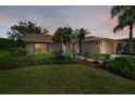 Inviting front exterior featuring lush landscaping, charming walkway, and a warm, welcoming ambiance at 1115 Ashbourne Cir, Trinity, FL 34655