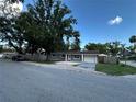 Charming single-story home with a lush green yard and a private driveway at 12009 Washington St, Seffner, FL 33584