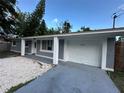 Charming home featuring a one-car garage with ample parking at 12009 Washington St, Seffner, FL 33584