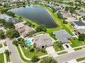 Beautiful aerial view of a home with a private pool, lush landscaping, and a lake nearby at 13728 Artesa Bell Dr, Riverview, FL 33579