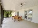 Covered patio with seating and ceiling fan, ideal for outdoor dining and relaxing at 1548 Foxboro Dr, Palm Harbor, FL 34683