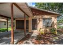 Close-up view of home's entrance and carport showing tidy landscaping and exterior details at 15623 Morgan St, Clearwater, FL 33760