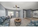 Comfortable living room with plush carpet, ceiling fan, and neutral wall paint at 15623 Morgan St, Clearwater, FL 33760