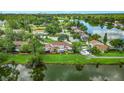 Beautiful aerial view of a lakeside community with lush green landscaping at 15636 Morning Dr, Lutz, FL 33559
