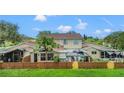 Charming home exterior featuring a fenced backyard, gazebo, and screened-in porch, perfect for outdoor living and entertaining at 15636 Morning Dr, Lutz, FL 33559