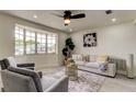 Bright living room featuring a large bay window, plush seating, and stylish decor at 3025 Palamore Dr, Holiday, FL 34691