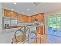 The open kitchen features stainless appliances, granite countertops, and counter seating at 3110 Royal Tuscan Ln, Valrico, FL 33594