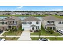 Aerial view of a beautiful home near a tranquil lake, surrounded by other residences at 33675 Elm Hill Br, Wesley Chapel, FL 33545