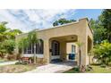 Single-story house featuring a stucco exterior, a practical carport, and verdant landscaping at 3611 W Bay To Bay Blvd, Tampa, FL 33611
