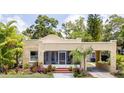 Inviting one-story home with stucco siding, a welcoming porch, and an attached carport for convenient parking at 3611 W Bay To Bay Blvd, Tampa, FL 33611