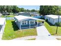 Bird's-eye view highlighting the home's carport, surrounding landscape, and neighborhood layout at 36435 Bonney Dr, Zephyrhills, FL 33541