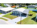 Aerial shot showcases this beautiful home with well-kept lawn, covered parking, and proximity to community features at 36435 Bonney Dr, Zephyrhills, FL 33541