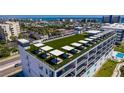 Close aerial of building rooftop offering lounge space and neighborhood views at 400 150Th Ave # 504, Madeira Beach, FL 33708