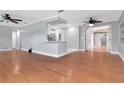 Open living room with hardwood floors and fresh gray paint shows space and updated design at 4317 S Hale Ave, Tampa, FL 33611