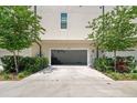 Spacious two-car garage with ample driveway, framed by green landscaping and a peek of home gym equipment at 4913 N Nebraska Ave # 5, Tampa, FL 33603