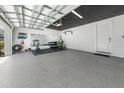 Spacious garage featuring epoxy floors, a black ceiling and a door to the main home at 4913 N Nebraska Ave # 5, Tampa, FL 33603