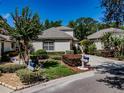Charming home with a well-manicured lawn, a two-car garage, and a neutral colored stucco exterior at 5224 Fairway One Dr, Valrico, FL 33596