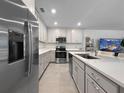Bright kitchen featuring stainless steel appliances, white countertops, and an open design with views of the living area at 5336 Patano Loop, Palmetto, FL 34221