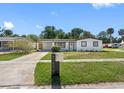 Inviting single-story home boasting a freshly manicured lawn and a convenient covered carport at 5618 Halifax Dr, Tampa, FL 33615