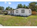 Beautiful single-story home featuring a bright white exterior, black trim, and a well-maintained lawn at 5618 Halifax Dr, Tampa, FL 33615