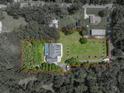 Aerial view of home showcasing pool, privacy and serene location of the property at 7427 20Th St, Zephyrhills, FL 33540