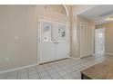 Bright foyer with double doors, neutral walls, and tiled flooring, and closet at 8671 Cypress Lakes Blvd, New Port Richey, FL 34653