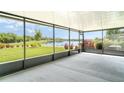 The screened patio offers serene views of the lake and beautiful landscaping at 9814 Quadrangle Ct, Sun City Center, FL 33573