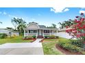 Inviting single-story home with a cozy front porch, beautifully landscaped yard, and a newly paved driveway at 1005 45Th W St, Bradenton, FL 34209