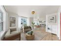 Bright, open-concept living room with hardwood floors, large windows, and contemporary decor with an adjacent dining room at 1005 45Th W St, Bradenton, FL 34209